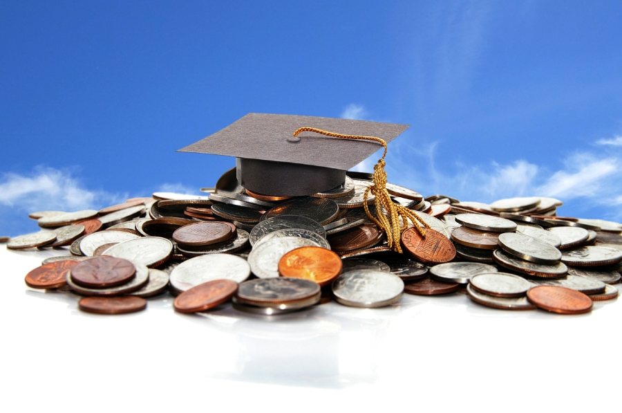 Graduation cap on a pile of coins